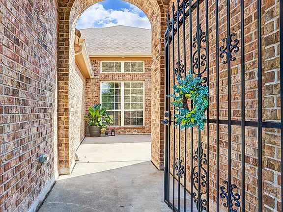 You will enter the home through iron gate into the private front courtyard. Plenty of room for a lovely garden or water feature.