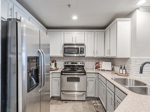 Thoughtful finishes including under cabinet lighting and subway tile backsplash