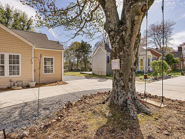 Tree swing at Hunsucker's Place, a revitalized 1942 cottage with charming curb appeal, off-street parking, and a prime location near Downtown Greensboro and Cone Health Hospital. Perfect for professionals and travelers seeking comfort and convenience.