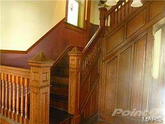 Gorgeous wood staircase and paneling in the front hall.