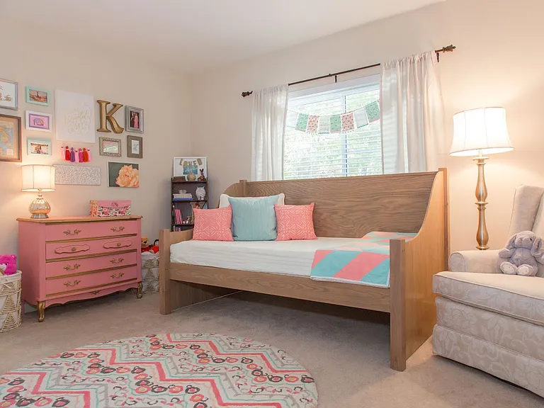 This is one of three spacious bedrooms. From the large picture window you can watch the butterflies and hummingbirds as they enjoy the hydrangeas, lilies, coneflowers, salvia, roses, gladiolus, irises, daisies, lavender, and other flowers in bloom!