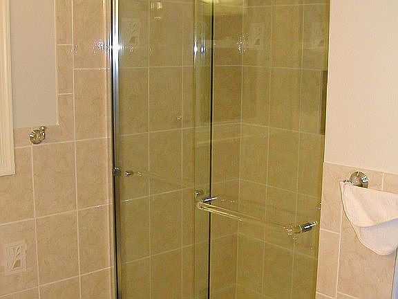 Wall tile w/ glass shower door 