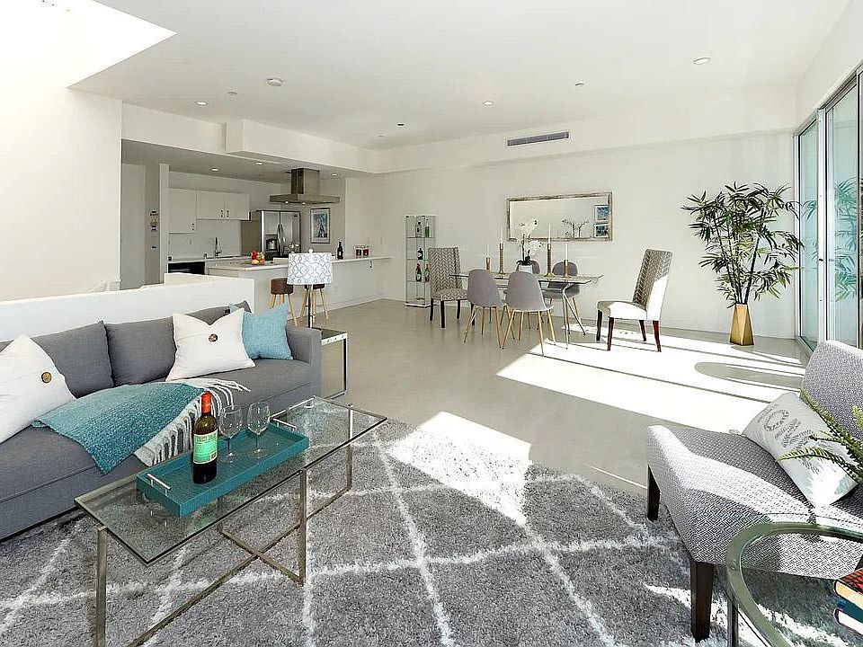 Open floor plan with floor to ceiling glasses and a large skylight letting plenty of lights.