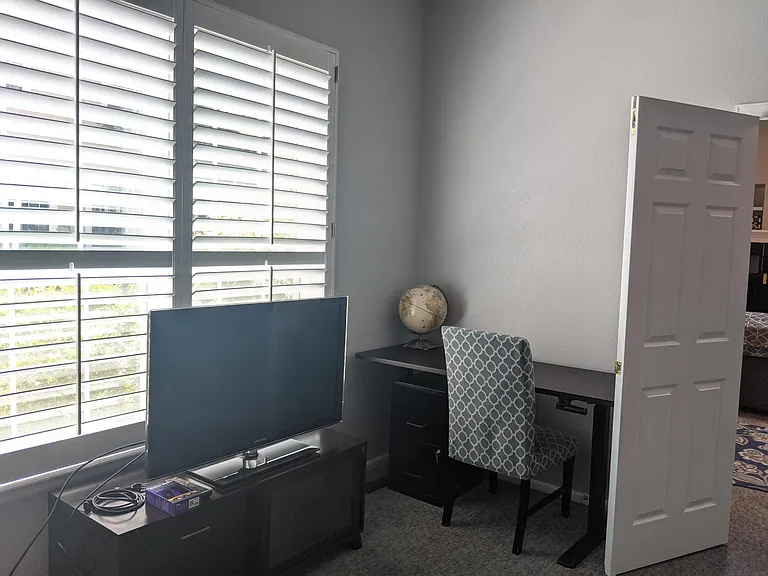 Main floor primary bedroom with Desk and Roku TV