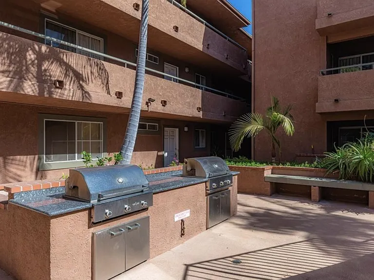 Community grilling area with outdoor BBQ grills, perfect for entertaining, relaxing, and enjoying outdoor dining with friends and family.