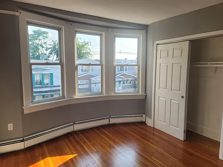 Well-lit Main bedroom with large closet for storage, room also has sliding doors.