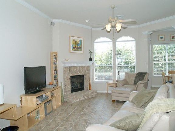 Bright, open living room with brick fireplace.