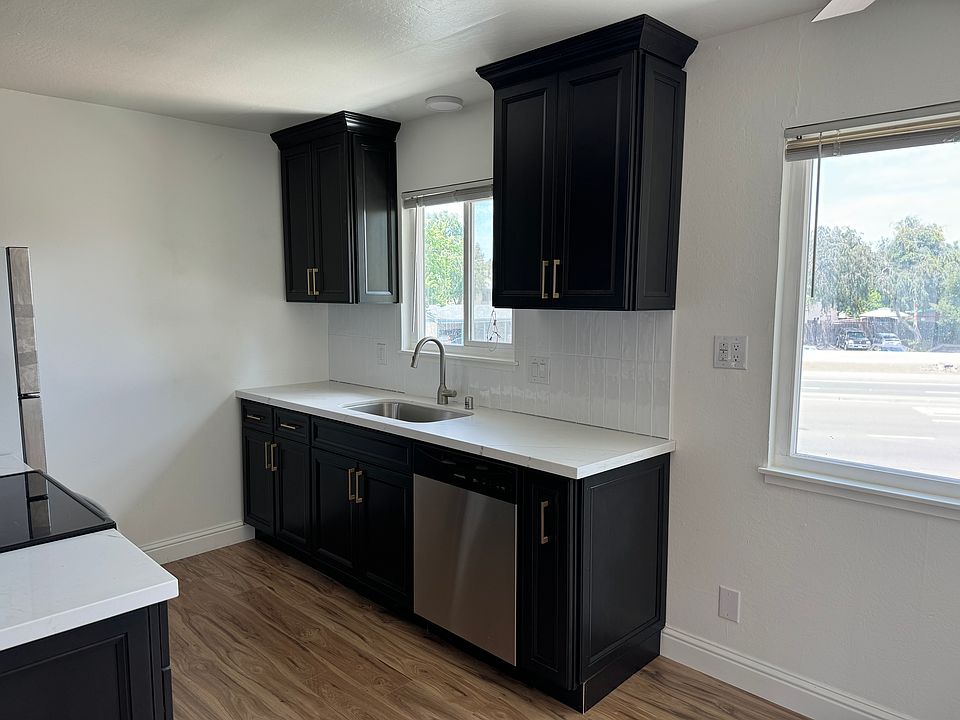 newly renovated kitchen with quartz countertops and stainless steel appliances