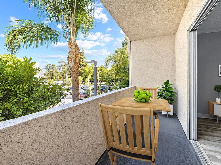 Large balcony with seating space and view of neighborhood of Chandler Circle Apartments.