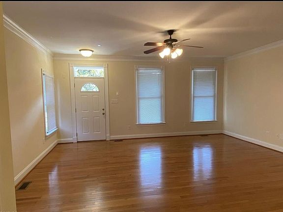 Living room, shown empty. Ceiling fan, walls and flooring all updated since this photo.