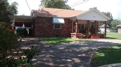 Front of house, carport on left.