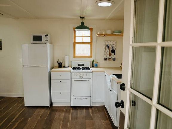 Fully renovated kitchen, new cabinets, brand new window, fridge, and vintage stove in great working condition