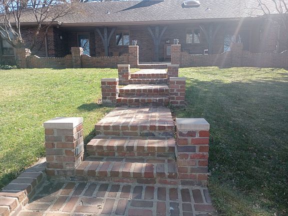 Lighted brick walkway to private entrance