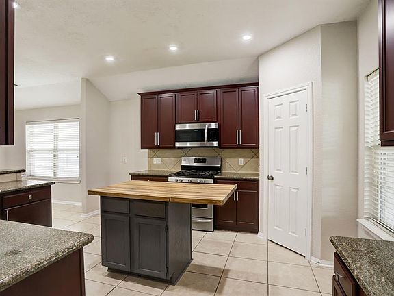 Granite countertops, stainless steel appliances, and a breakfast bar are a few features that stand out.