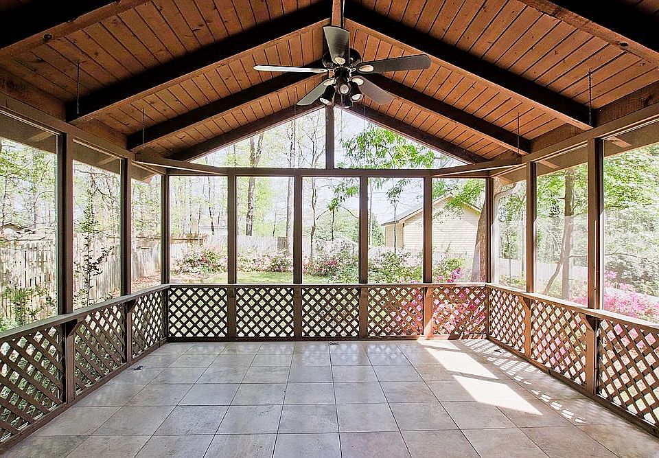 Screened in porch. Tiled floor. Ceiling fan. Exit into fenced in yard.