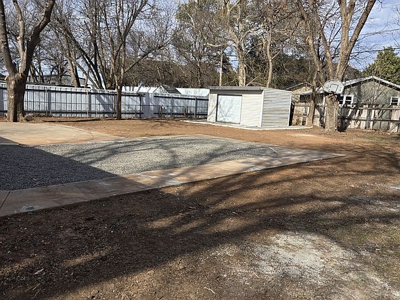 Back yard with storage shed.