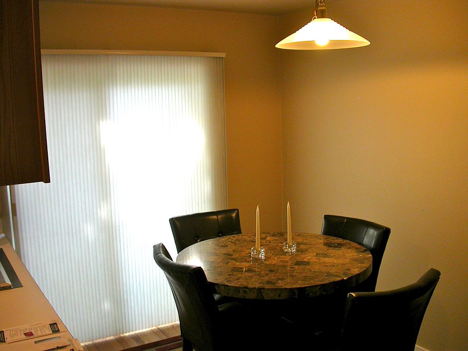Eating area near kitchen with sliding glass door to outdoor patio.