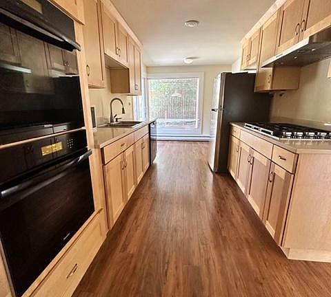 Kitchen with double Miele Ovens a Cooktop and Miele dishwasher plus a microwave