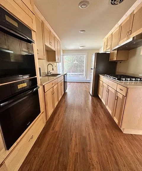 Kitchen with double Miele Ovens a Cooktop and Miele dishwasher plus a microwave