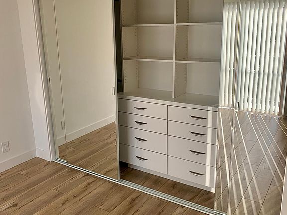 Custom closets with built in organization in bedroom