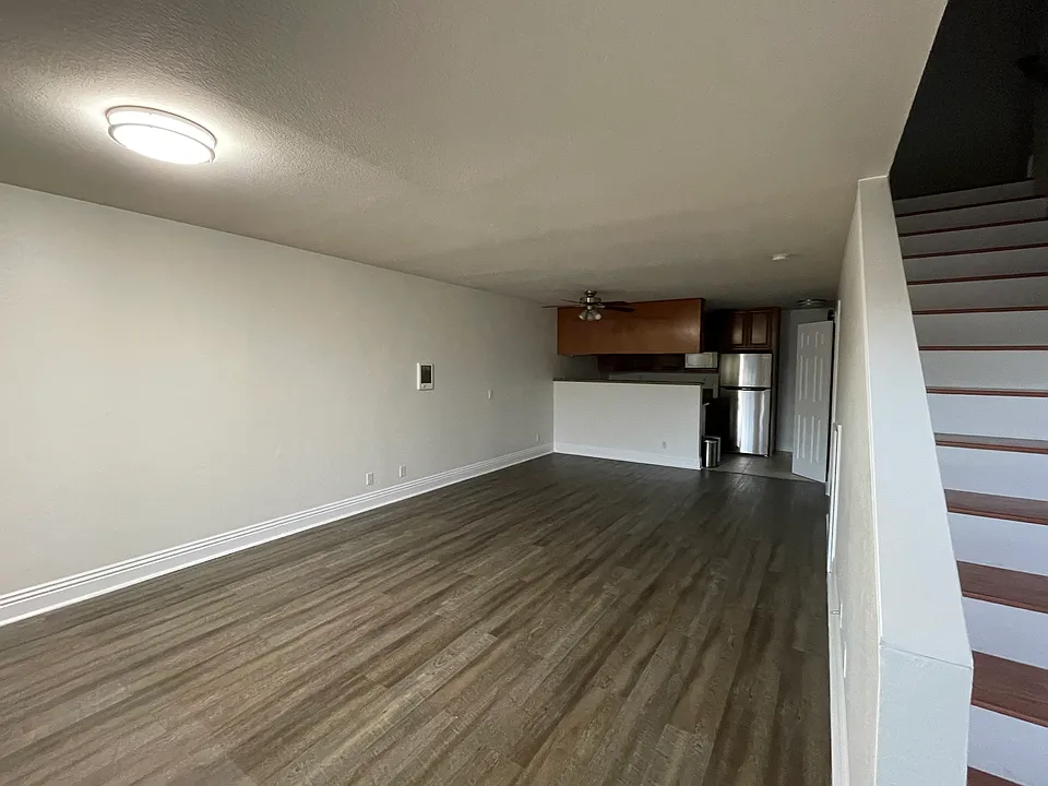 View from front entry - living area, kitchen, laundry area and downstairs bathroom.
