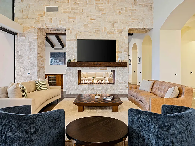 The great room offers a fireplace where the whole family can gather for a nice evening in.
