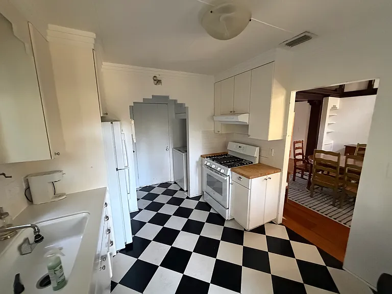 Gas range and washing machine, refrigerator on L, door opens to garage, doorway to the R opens to the dining room