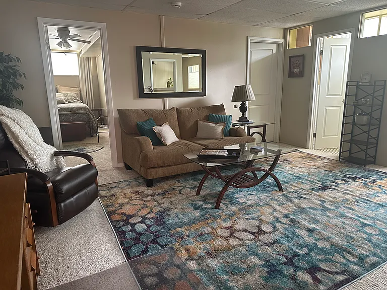Living area includes a sofa, leather recliner, tables and lamps for your comfort.