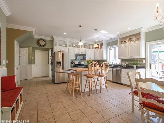 Custom built kitchen with high ceilings, crown moldings and charming wainscoting.