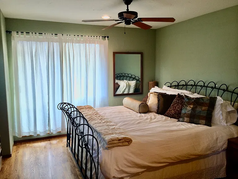 Upstairs primary bedroom with access to west facing balcony. Relax and enjoy the mountain views.