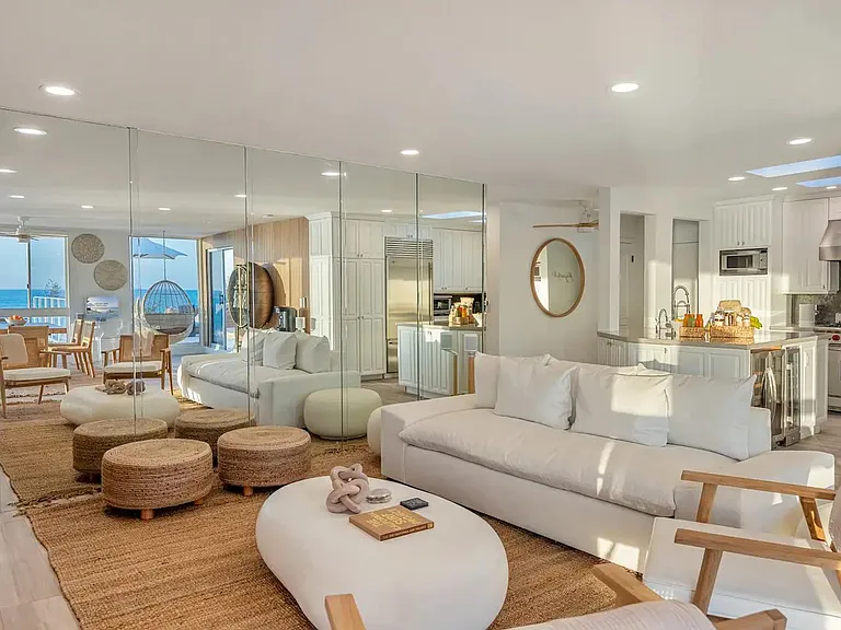 Reflect timeless elegance in the living room with a chic mirror wall at Aqualina.