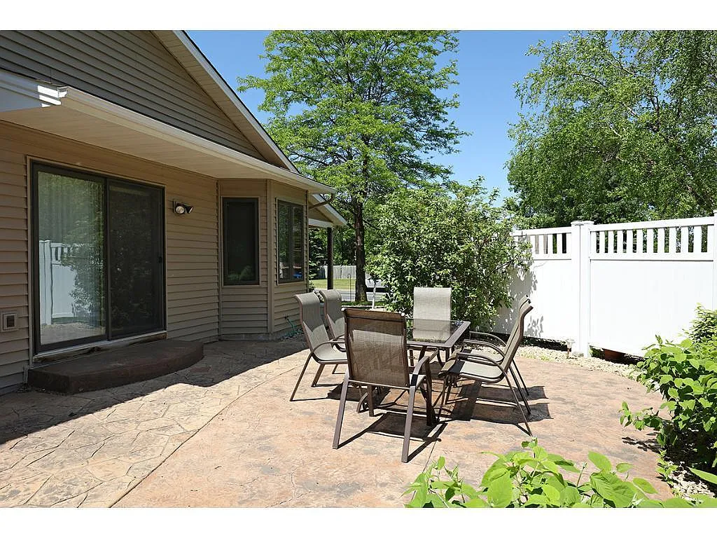 Stunning stamped concrete patio with privacy fence - 7666 170th St W