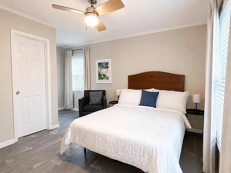 A chair, 2 bedside tables + 2 lamps for ease and comfort
