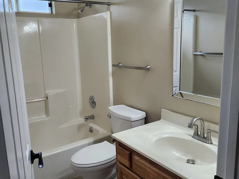 Hall Bathroom located adjacent to Bedroom#2 & Bedroom#3 for their use. Nice, clean vanity with good lighting.