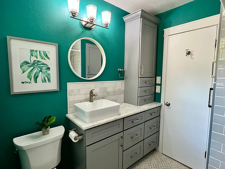 Bathroom
Features: Grey shaker cabinets with soft close doors and drawers, marble countertop, marble mosaic on the floor and shower. Tons of storage space between the vanity and linen cabinet.