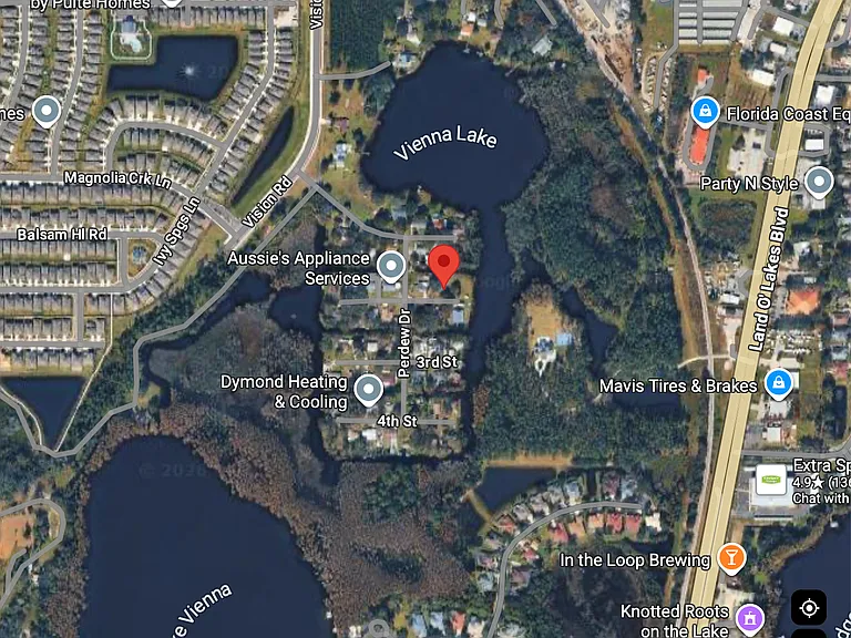 Satellite photo of PERDEW ISLAND showing location of property with red dot and access to both private lakes