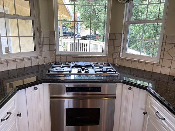 Gas cooktop with views to the front deck and street in the cook's kitchen.