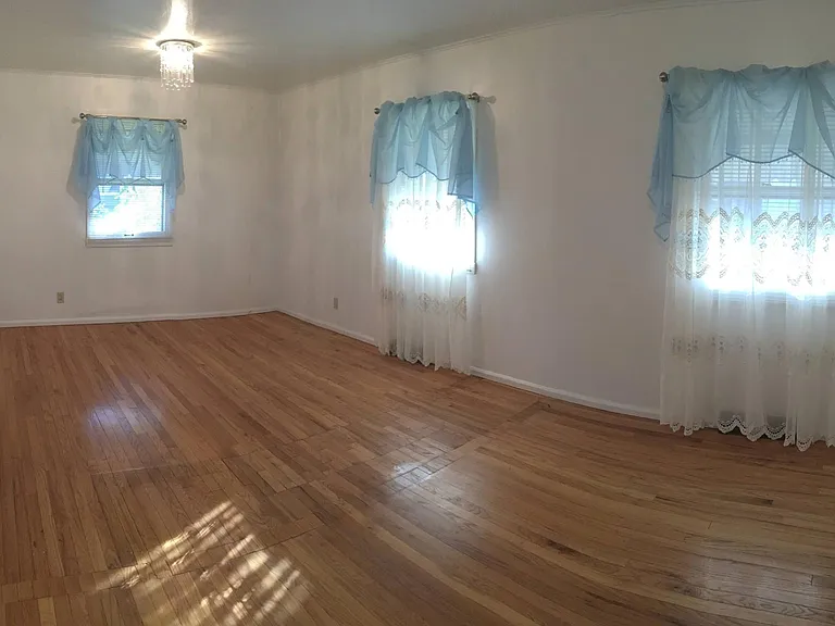 Large bedroom. A ceiling fan has been added recently.