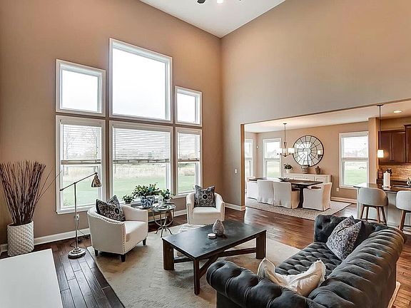 Great Room/with high ceiling and wall of windows. Beautiful view of the golf course and lake