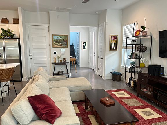 Living room, looking toward front door. The half bath is located just before the staircase.