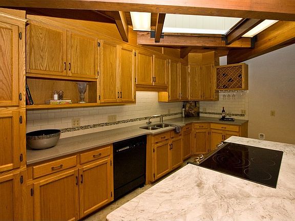 New tile floor complements the soft grey granite & golden oak cabinets.