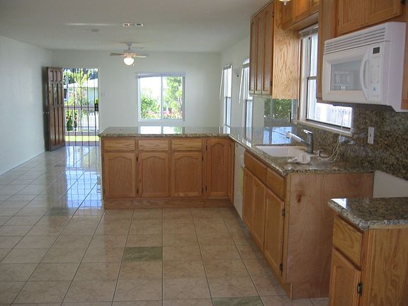 House kitchen and living area w/new tile, cabinets and granite countertops