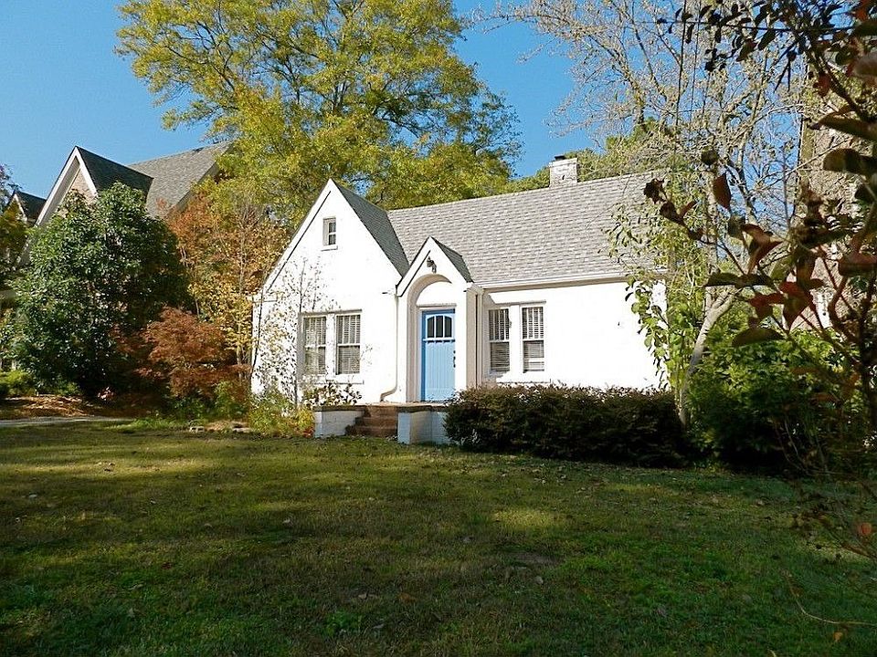 Perched beautifully on a raised level lot on one of Lake Claire's most desired streets