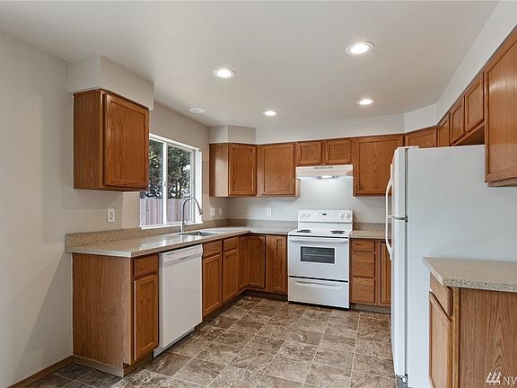 The chef-friendly kitchen has been tastefully updated with quartz counters and an undermount stainless sink. 