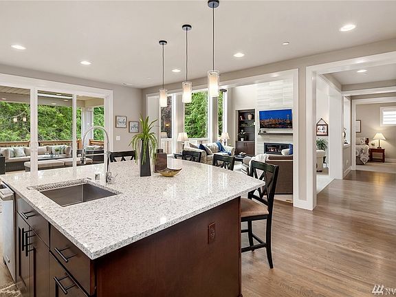 Check out the massive island with breakfast bar and elegant 3 cm quartz counters!