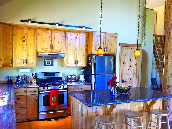 Granite counter tops and stainless appliances highlight this amazing, open kitchen.