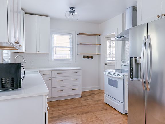 Well appointed kitchen with quartz countertops, updated cabinetry, fridge, stove, microwave and dishwasher included.