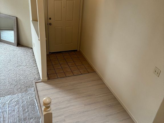 Entry area: in this photo, contractors are still working on home. plastic wrap on floor to protect carpet