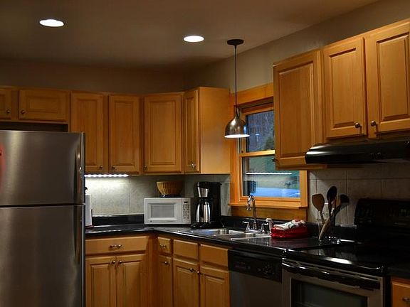 Kitchen with stainless steel refrigerator, dishwasher, range