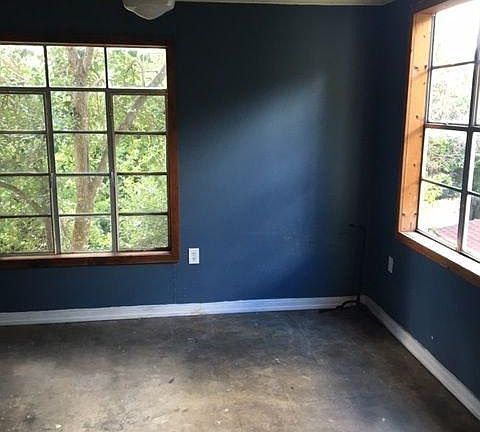 rear bedroom with concrete floors and private entrance